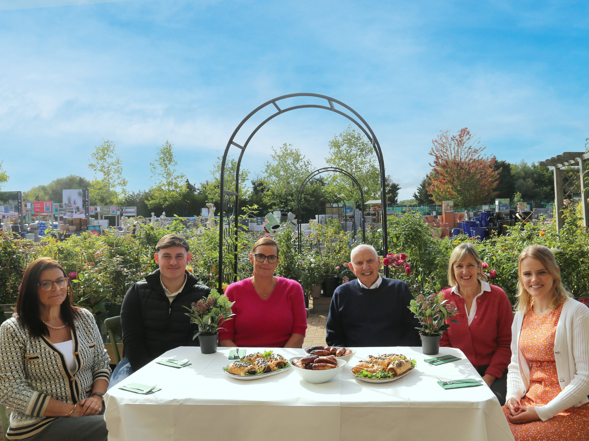 Representatives of Squire's and Porky Whites, two third-generation family businesses, sitting together around a garden-centre table